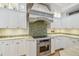 This kitchen showcases a modern oven, tile backsplash, and bright white cabinets at 3105 W San Isidro St, Tampa, FL 33629