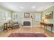 A cozy living room featuring a fireplace and hardwood floors, with soft natural light at 3105 W San Isidro St, Tampa, FL 33629