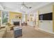 Comfortable living room with a fireplace, built-in cabinets, and a view of the kitchen at 3105 W San Isidro St, Tampa, FL 33629