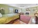A serene bedroom featuring a fireplace, hardwood floors, and natural light at 3105 W San Isidro St, Tampa, FL 33629