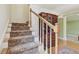 A staircase with patterned carpet, a wooden handrail, and decorative details at 3105 W San Isidro St, Tampa, FL 33629