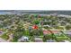 Aerial shot of neighborhood with mature trees, lush lawns, and a peek of the bay at 3207 Hilltop Ln, Largo, FL 33770