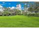 Lush backyard with mature landscaping, shade trees, and space for outdoor activities at 3207 Hilltop Ln, Largo, FL 33770