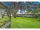 Green backyard with beautiful landscaping, mature shade trees, and privacy hedges at 3207 Hilltop Ln, Largo, FL 33770
