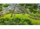 Lush backyard featuring meticulously maintained landscaping and open green space at 3207 Hilltop Ln, Largo, FL 33770