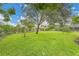 Lush backyard featuring meticulously maintained landscaping and mature shade trees at 3207 Hilltop Ln, Largo, FL 33770