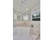 Spacious bathroom featuring a corner tub, decorative tiles, and a window for natural light at 3207 Hilltop Ln, Largo, FL 33770