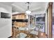 Dining area features a chandelier, wood cabinets, and access to outdoor seating at 3207 Hilltop Ln, Largo, FL 33770