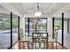 Dining area featuring a glass table set and bright views of the backyard pool at 3207 Hilltop Ln, Largo, FL 33770