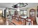 Elegant dining room features a large table, mirrored wall, and decorative chandelier, ideal for formal dinners at 3207 Hilltop Ln, Largo, FL 33770