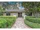 Inviting front entrance with stone accents and professionally landscaped surroundings at 3207 Hilltop Ln, Largo, FL 33770