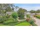 Beautiful landscaping with green lawns and mature trees enhances the home's curb appeal at 3207 Hilltop Ln, Largo, FL 33770
