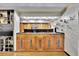 A charming kitchen showcasing wooden cabinets, black backsplash and textured walls at 3207 Hilltop Ln, Largo, FL 33770