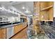 Kitchen features sleek stainless steel appliances, wood cabinets and granite countertops at 3207 Hilltop Ln, Largo, FL 33770