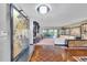 View of open living room with hardwood floors, custom room divider, and access to back patio at 3207 Hilltop Ln, Largo, FL 33770