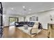 Bright living room with hardwood floors, ceiling fan, and access to the outdoors at 3207 Hilltop Ln, Largo, FL 33770