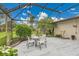 Screened patio with dining area, lush landscaping, and ample space for relaxing at 3207 Hilltop Ln, Largo, FL 33770