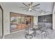 Covered patio area with a view of the indoor dining area, sitting area, and custom ceiling fans at 3207 Hilltop Ln, Largo, FL 33770
