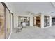Spacious patio with ceiling fan, dining set and sliding glass doors to pool and kitchen at 3207 Hilltop Ln, Largo, FL 33770