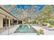 Beautiful screened-in pool featuring a tile deck, landscaping, and room for seating at 3207 Hilltop Ln, Largo, FL 33770