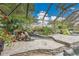 The gorgeous waterfall feature adds a touch of paradise to the beautiful screened pool and yard at 3207 Hilltop Ln, Largo, FL 33770