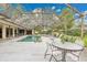 Outdoor dining set near the screened-in pool, perfect for entertaining at 3207 Hilltop Ln, Largo, FL 33770