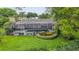 A beautiful screened in pool sits in the well manicured lawn at 3207 Hilltop Ln, Largo, FL 33770