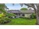 A large screened-in pool sits at the back of the home and surrounded by a meticulously kept lawn at 3207 Hilltop Ln, Largo, FL 33770