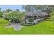 A large screened pool sits in the rear of the home surrounded by an artfully designed lawn at 3207 Hilltop Ln, Largo, FL 33770
