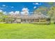 Expansive screened-in porch with ample seating and lush landscaping provides a tranquil outdoor living space at 3207 Hilltop Ln, Largo, FL 33770
