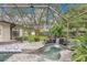 The pool features a rock waterfall that enhances the tropical feel of the backyard at 3207 Hilltop Ln, Largo, FL 33770