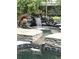 A relaxing rock waterfall adds charm to the screened-in pool area at 3207 Hilltop Ln, Largo, FL 33770
