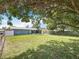 Generously sized backyard with well-maintained lawn, screened porch, and mature trees at 3271 36Th N St, St Petersburg, FL 33713