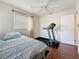 Bedroom with a bed, wood floor, ceiling fan and a treadmill for exercising at 3271 36Th N St, St Petersburg, FL 33713