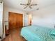 Comfortable bedroom featuring a ceiling fan, wood floors, and closet with wood sliding doors at 3271 36Th N St, St Petersburg, FL 33713