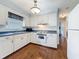 Inviting kitchen with hardwood floors, white cabinets, and stainless steel appliances at 3271 36Th N St, St Petersburg, FL 33713