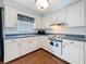 Bright kitchen featuring ample counter space, white cabinets and a stainless steel sink at 3271 36Th N St, St Petersburg, FL 33713