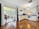 Bright kitchen with hardwood floors, white cabinetry, modern appliances, and access to a sunroom at 3271 36Th N St, St Petersburg, FL 33713