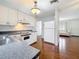 Bright kitchen with white cabinets, hardwood floors, and white appliances offers an inviting space at 3271 36Th N St, St Petersburg, FL 33713