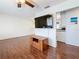 A cozy living room featuring hardwood floors, a ceiling fan, and access to the kitchen at 3271 36Th N St, St Petersburg, FL 33713