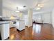 Open concept kitchen and living room with hardwood floors, white cabinets, and lots of light at 3271 36Th N St, St Petersburg, FL 33713