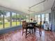 Sunroom with table and chairs, surrounded by windows offering views of the outdoor area at 3271 36Th N St, St Petersburg, FL 33713
