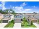 Aerial view of two-story home featuring landscaping, well maintained lawn, and a two car garage at 36312 Garden Wall Way, Zephyrhills, FL 33541