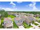 Aerial view of a neighborhood featuring manicured lawns, landscaping, and two-story homes at 36312 Garden Wall Way, Zephyrhills, FL 33541