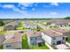 Close aerial view of new homes in a Primary-planned community with well-maintained yards at 36312 Garden Wall Way, Zephyrhills, FL 33541