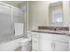 Bathroom featuring granite counters, white vanity, a shower-tub and a mirrored wall cabinet at 36312 Garden Wall Way, Zephyrhills, FL 33541