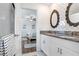 Modern main bathroom with double sinks and an open view of the bedroom at 36312 Garden Wall Way, Zephyrhills, FL 33541