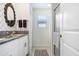 Modern bathroom featuring granite countertops, dual sinks, and tiled shower at 36312 Garden Wall Way, Zephyrhills, FL 33541