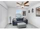 Bedroom featuring carpet floors, blue couch, gray ottoman, a window, ceiling fan and closet at 36312 Garden Wall Way, Zephyrhills, FL 33541