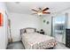 Cozy bedroom with ceiling fan, window, carpeted floor, comfortable bed and closet at 36312 Garden Wall Way, Zephyrhills, FL 33541